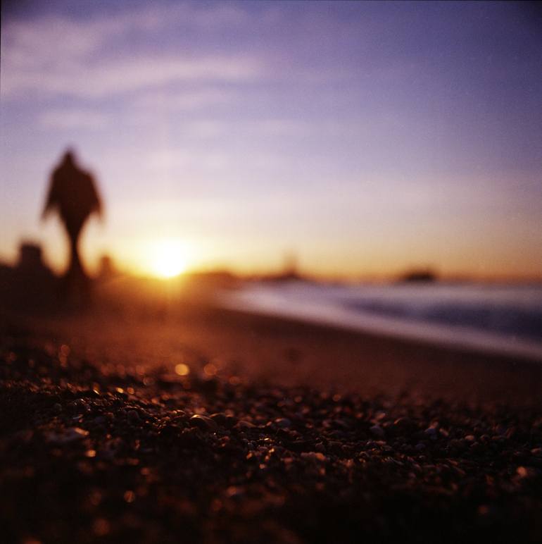 Man walking on beach at sunset square color analogue medium format film ...