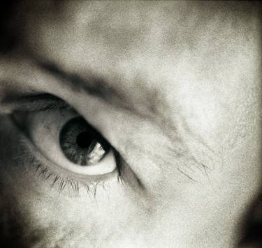 Closeup of eye of man black and white sepia tone 35mm silver gelatin analog portrait macro photograph thumb