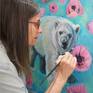 Christine Montague in the artist studio painting "Polar Bear and the Pink Poppies" 24" x 24" oil painting on canvas.