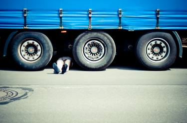 the mechanic under the truck trailer thumb