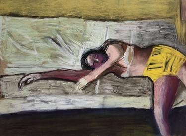 Young girl in yellow shorts lying on a sofa thumb