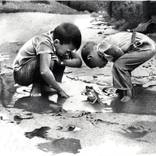 Untitled - Two boys hunting for frogs by David J Vanderpool