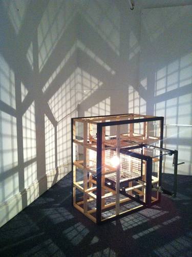 fixed source of light within a moving cube constructed in a solid framwork thumb