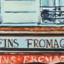 Two people looking at a shop window full of French "goodies".