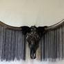 KoKo Texas longhorn skull sculpture. Skull is a highly lacquered spectra petroleum effect, each eye
socket is encrusted with black diamond swaroski crystals, natural horns has individual
hanging chain in black, silver and gun metal in approx lengths of 55cm-60cm. It has
a battery operated green LED lighting system, around the horns near the skull is
covered with black coque feathers. 138Cm x50cmx 90cm MEANS NIGHT IN BLACK FOOT