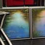An original oil painting.  Reflections of evening light on a still waterlily pond.
Framed in a wooded box floating frame, hand painted.