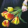 Detail of yellow and red tulips , with the girl's hand.