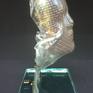 The sculpture was created after melting the glass format on the copper mesh (face). The sculpture is fastened with steel holders to the glass base (self-assembly).