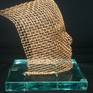 A copper mesh face, fastened with copper wire from a glass base. All my work combines the mesh ...