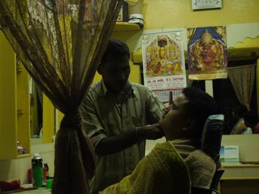 Two men in a Kathmandu back alley barber shop thumb