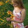 Late evening in the garden. Beautiful northern light. Young women arranging flowers.