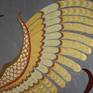Details of a wing with it gold feathers.