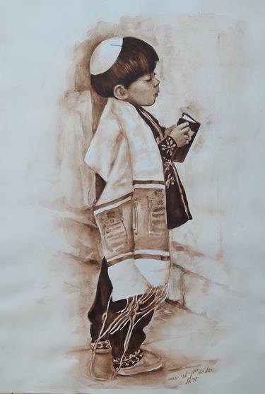 A boy praying at the Western Wall thumb