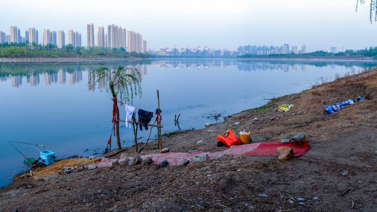 Original Landscape Photography by Bo Chen | Conceptual Art on Paper | Red carpet by the border river at dusk