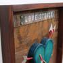 Sculptural Art, Shadow Box Style. The art piece has a solid wood heart sculpture with 7 handmade arrows. The tips and back of the arrow are hand made from aluminum plates.
The title of the artwork has an acrylic plate on top.