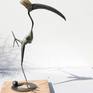 A migratory bird from northern Europe flies south in the winter.
“sculpture has one leg that move into 2 positions”