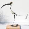 A migratory bird from northern Europe flies south in the winter.
“sculpture has one leg that move into 2 positions”