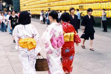 three young women wearing colourful kimono on an afternoon stroll at a lantern festival thumb