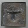 This bronze plaque depicts the head of a Siamese cat; it comes with a wooden stand but is also fit to hang on the wall.