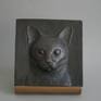 This bronze plaque depicts the head of a Siamese cat; it comes with a wooden stand but is also fit to hang on the wall.