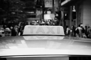 roof light on silver public taxi on a shopping street in hong kong thumb