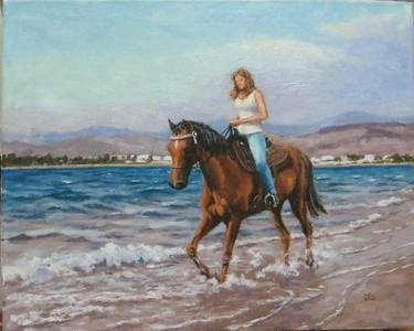 girl riding a horse on the beach thumb