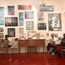 Overall shot of studio wall. Painting is in the center of the photograph.