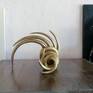 This sculpture makes me think about magic universe and parallel realities. It is made of artificial clay , painted with chrome gold acrylic color and finished with a glitter spray. Parallel twisted rays represent cosmic womb where all ideas are already present and all realities are possible,.I am always amazed about quantum physics mistery
.
The scupture can be positioned horizontally and vertically and small pearl white heart can be added to transfer cosmic love into your home.