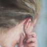 This is a second adaption of the image of a girl with green behind her ears. It is a reference to a german saying, "gruen hinter den Ohren sein", which literally translates as to be green (or to have green) behind the ears means that someone is naive.