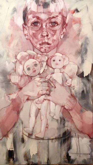 Child holding dolls thumb