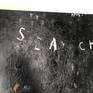 SEARCH is written in a metallic silver paint that lightly reflects with the right lighting.