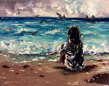 Girl sitting on the beach daydreaming thumb