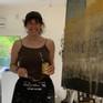 Contemporary latin-american artist Alicia savio at her art studio ending the painting "Casa Grande"