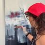 Contemporary Latin American artist Alicia Savio painting in her art studio