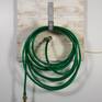 Light Watering / work shown with "watering hose" turned off, hanging on white studio wall.