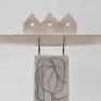 White boat on a white and grey column. The ceramic ship and the column are coated with layers of colored slips, glaze and ceramic pigments, thus creating an alternating glossy or matt surface.