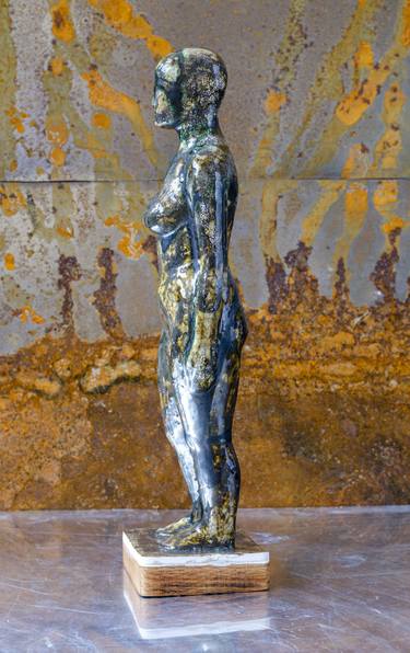 The metallic colored woman figure thumb