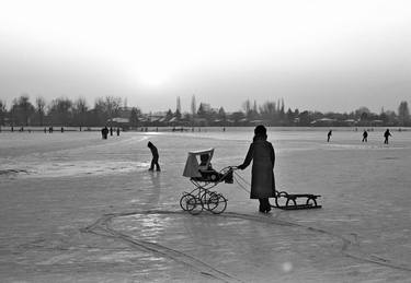 Woman mit baby carriage on ice thumb