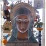 concave face of Virgin Mary, plastic cartoon figurines and electronics, cast in polyester resin.