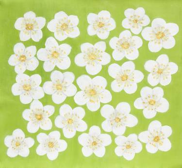 White spring flowers on light green thumb