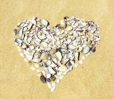 Heart from shells on sand thumb