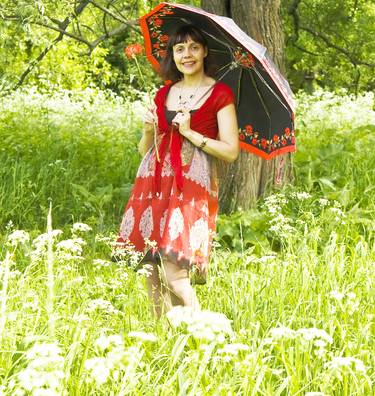 Beautiful woman with umbrella on summer meadow thumb