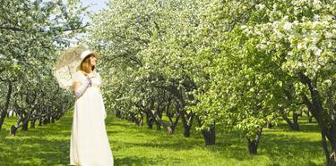 Woman in white in apple garden thumb
