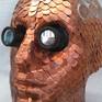 A life size polystyrene head covered in hand punched copper scales and one pence coins, with Jewellers lenses for eyes.