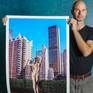 From a limited edition of 5 archival photographs
Signed and numbered by artist A K Nicholas

Blush pink verticals dominate this image in three scales: the buildings, the model’s legs, and her high heeled shoes. The blue negative space of the sky pierces downward in pencil thin slivers between the buildings.