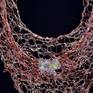 Woven wire with resin, metal powders and cast glass components.
