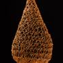 This long, hanging form plays with the illusion of gravity, making it seem as though the shapes are hanging and stretching with weight. The sculpture is actually hardened and held in these three bulb shapes that ascend in size from top to bottom of the piece. The shape of the bulbs transition from diamond to tear drop at the bottom.