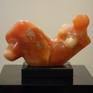 orange semi-translucent original stone carving of woman looking to heaven