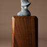 Bronze miniature sculpture of a woman bundled in her shawl and making her way through a winter storm. 
Bronze is 2.75″ H 
Available on large or small base.
Edition of 240