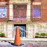 Detail of front entrance with street art and orange cone